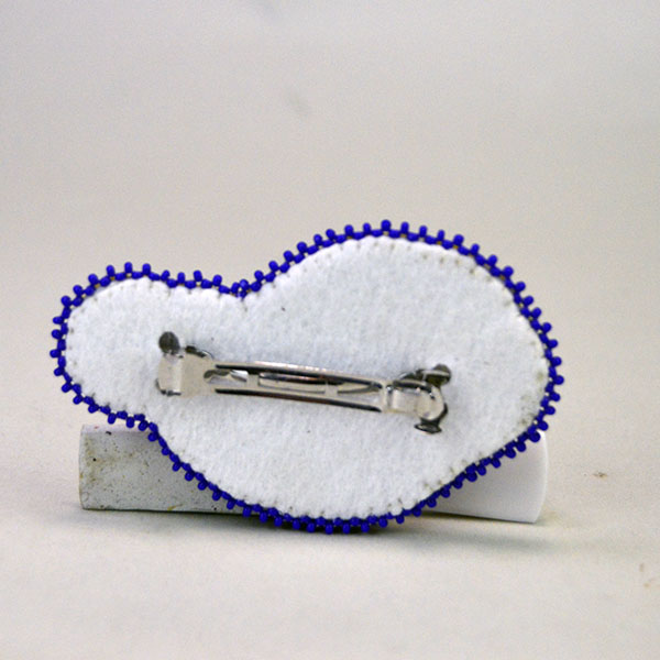 Handcrafted Barrette- Beaded Flower by Andy Bullock, featuring vibrant French repro beads and a bold three‑dimensional edge. Approx. 3.5" x 2.25″ . The back showing the clip and the white pellon fabric.
