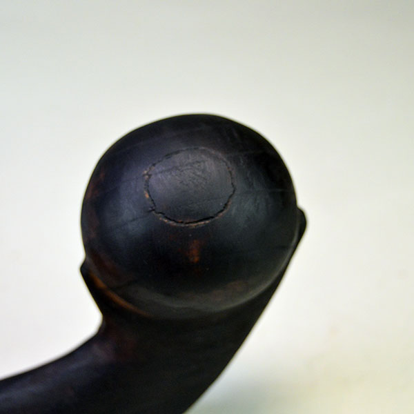 This 18-inch straight wooden club reflects Chris Bullock’s refined fire‑burnishing technique. Chris applied mineral oil, to enriching the color. Another mark on the ball.