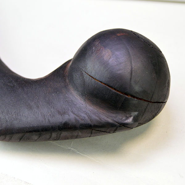 This 18-inch straight wooden club reflects Chris Bullock’s refined fire‑burnishing technique. Chris applied mineral oil, to enriching the color. One of the cracks on the ball.