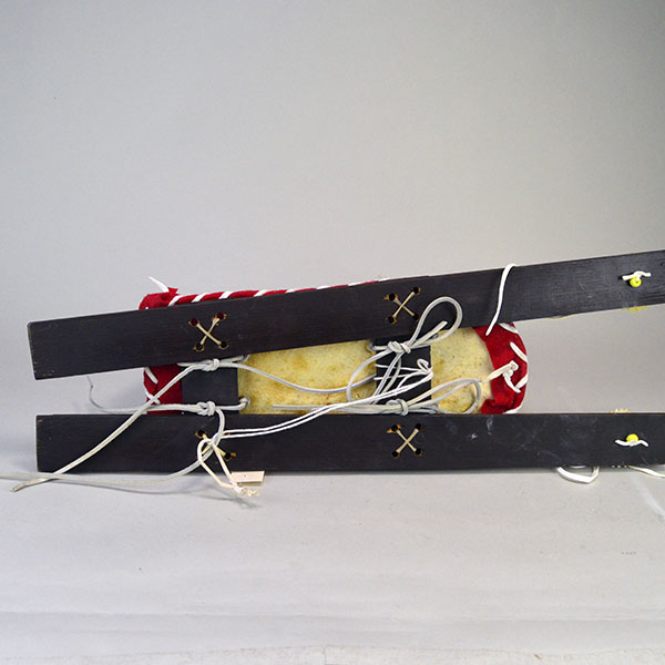Cradleboard Parfleche features rawhide construction and a hand‑painted design. measures approximately 21 inches long, 7 inches wide at the head. The Bottom view.