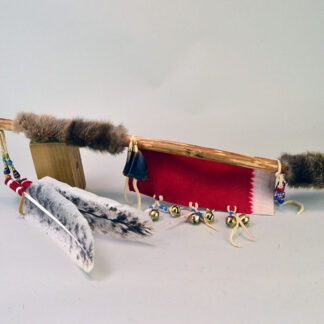 Handcrafted Dance Stick with Otter fur. Approx. 26.5" Dance Stick with otter fur, feathers, brass beads, deer toes and red wool accents. One of a Kind.