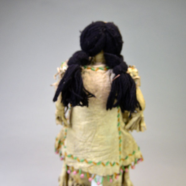 This antique Doll- Northern Plains Style offers exceptional handmade detail and strong visual presence. She stands approx. 14 inches tall. One of a Kind. The back.