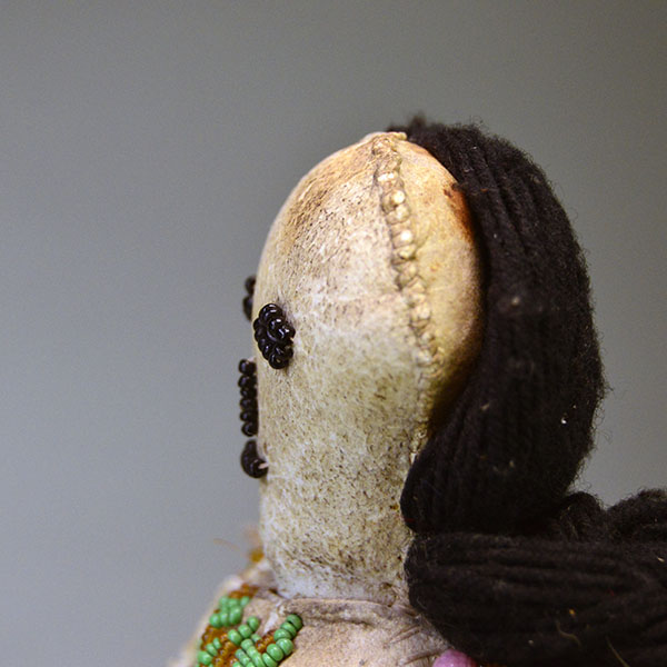 This antique Doll- Northern Plains Style offers exceptional handmade detail and strong visual presence. She stands approx. 14 inches tall. One of a Kind. The top of the head stiching.