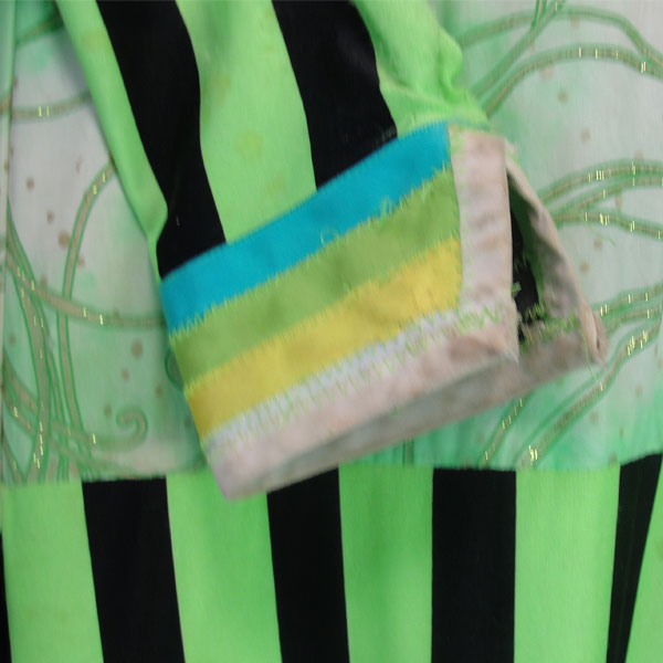 Child’s Jingle Dress, This Child’s Jingle Dress features a green and white top fabric decorated with sequins and glitter designs. Child’s Size Medium/Large. the cuff , the striped sleave, and dress part.