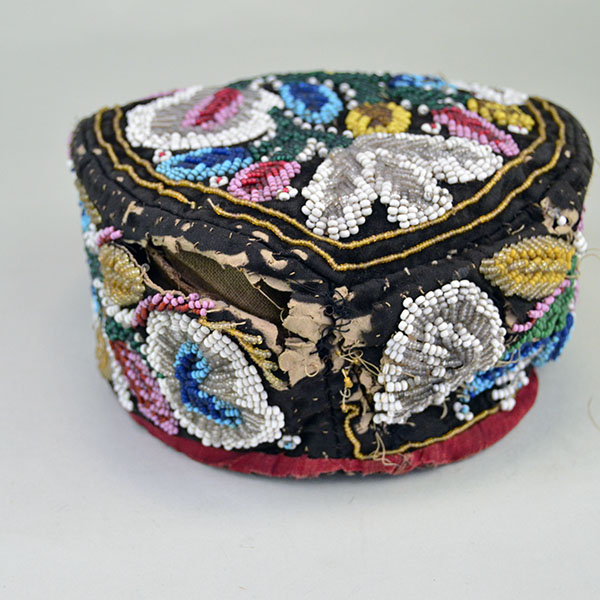 Antique Hat- Antique Beaded Glengarry, brown velveteen cap with a classic Iroquois‑style floral motif. hat shows wear, some bead loss. One of a Kind. The front view.