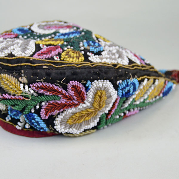 Antique Hat- Antique Beaded Glengarry, brown velveteen cap with a classic Iroquois‑style floral motif. hat shows wear, some bead loss. One of a Kind. Aside view.