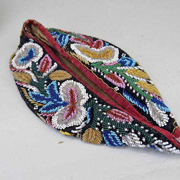 Antique Hat- Antique Beaded Glengarry, brown velveteen cap with a classic Iroquois‑style floral motif. hat shows wear, some bead loss. One of a Kind. The bottom of the cap.