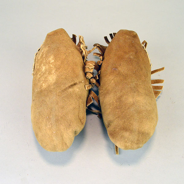 Moccasin- Child Center Seam, brick‑stitched the vamp in white, mustard yellow, and red‑orange. Like new , never worn, estimated child’s size 8–9. the bottoms. showing never worn.
