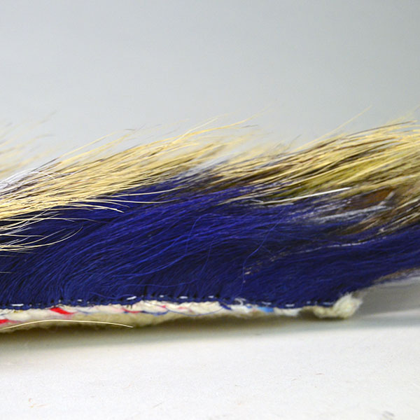 14" Dark Blue Roach is a well‑constructed, eye‑catching piece. Handmade braided‑yarn base, dark blue on the outside and white on the inside. The side showing the blue.