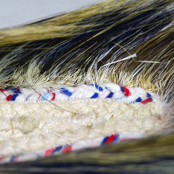 14" Dark Blue Roach is a well‑constructed, eye‑catching piece. Handmade braided‑yarn base, dark blue on the outside and white on the inside. I the inside at the end of the base.