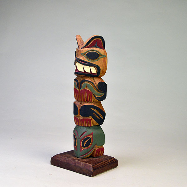 Hand‑carved Totem Pole 9" features a bear on top and a frog at the base. back is etched ‘L. Rudick,’ , is Larry Rudick is a Pacific Northwest carver. The other side.
