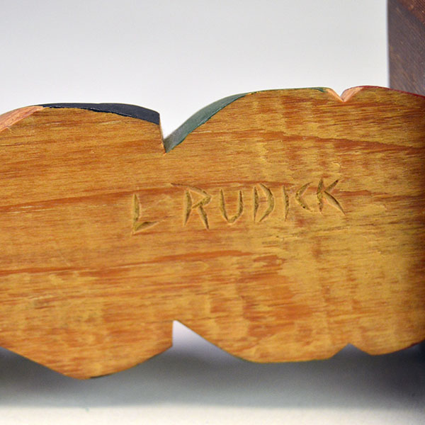 Hand‑carved Totem Pole 9" features a bear on top and a frog at the base. back is etched ‘L. Rudick,’ , is Larry Rudick is a Pacific Northwest carver. larry's carved signature