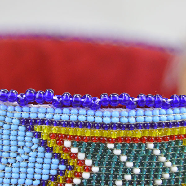 Striking Turban- Beaded with Otter will make a standout addition to your regalia. A vintage 1.5‑inch beaded strip on top, 23" in inside circumference. The edge beading.