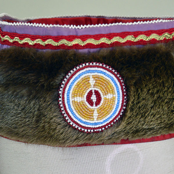 Turban Crafted in Otter Fur features six rosettes measuring between 1.25" x 2.5". approx. 21.5 inches inside circumference, drop measures about 24 inch". Another view of the otter fur, rosette and ribbon with with the edge beading.