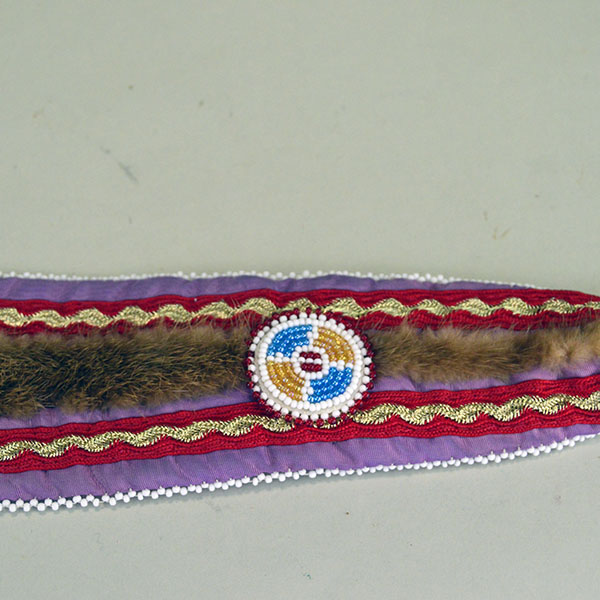 Turban Crafted in Otter Fur features six rosettes measuring between 1.25" x 2.5". approx. 21.5 inches inside circumference, drop measures about 24 inch". Another view of the drop and the ribbon work with the rosette.