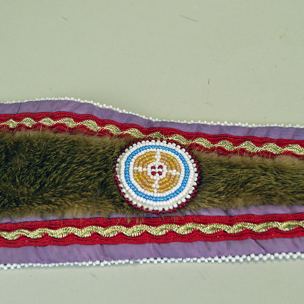 Turban Crafted in Otter Fur features six rosettes measuring between 1.25" x 2.5". approx. 21.5 inches inside circumference, drop measures about 24 inch". A rosette on the drop show casing the ribbon work.