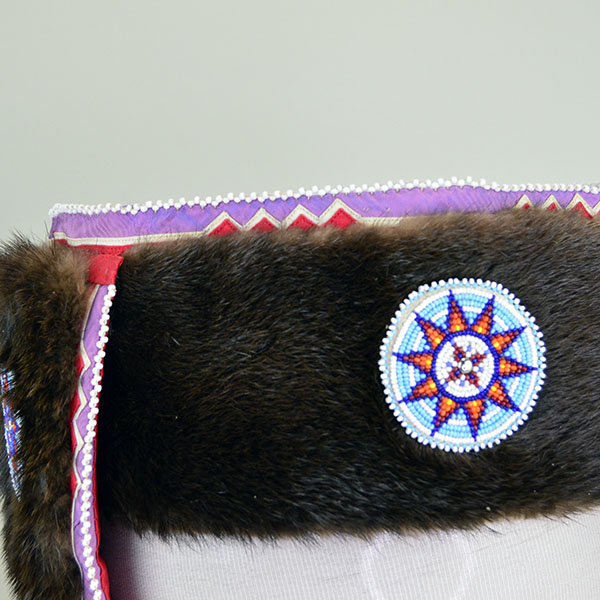 Turban- Handcrafted Otter fur features six rosettes. approximately 22 inches in inside circumference. The drop measures about 26 inches. one of a kind. The rosette and the beaded edging on the top of the turban.