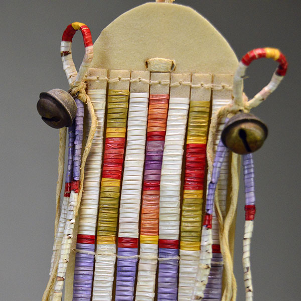 Wapegnaki- Hair Ornament Quilled features 9″ of quillwork on a 10″ rawhide base. Eight 5″ quilled tassels hang from the piece, 23″ dark horse‑hair drop. The top.