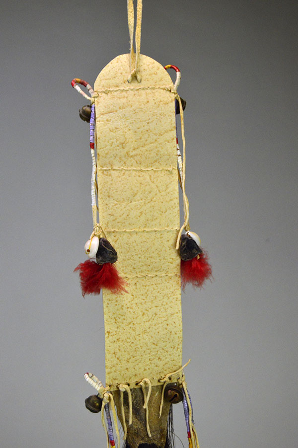Wapegnaki- Hair Ornament Quilled features 9″ of quillwork on a 10″ rawhide base. Eight 5″ quilled tassels hang from the piece, 23″ dark horse‑hair drop. The back raw hide.