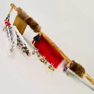 Handcrafted Dance Stick with Otter fur. Approx. 26.5" Dance Stick with otter fur, feathers, brass beads, deer toes and red wool accents. One of a Kind.