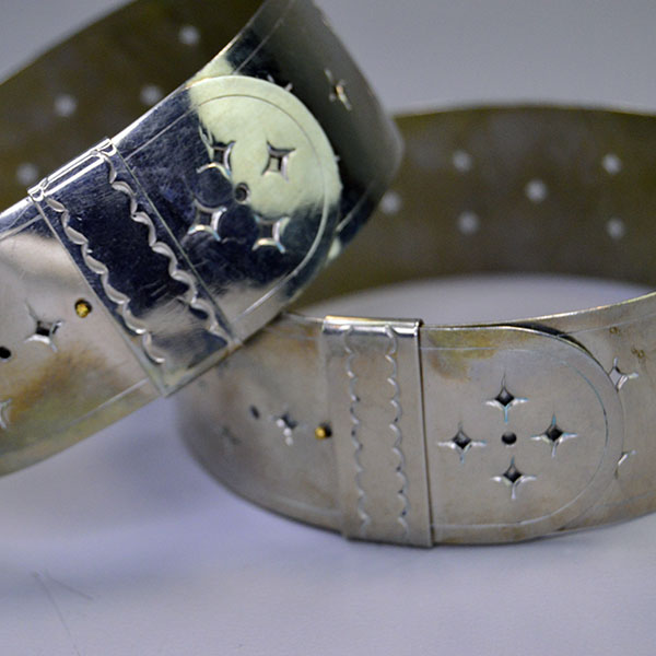 Handmade German Silver Armbands- Star Motif with a punched star design; adjustable 1.25" x 14" bands crafted for Powwow regalia and Living History wear. The outside showing the adjustable slip hooks.