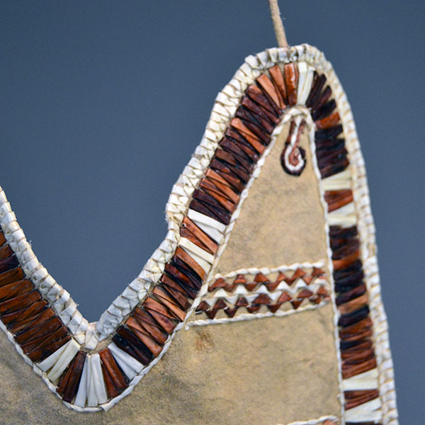 Bag- Quilled Thunderbird Motif with Braintanned leather, otter fur, deer‑hair drops, and antique white pony beads. Measures approx. 14.5" × 6". here is one of the corners on the top of the bag.