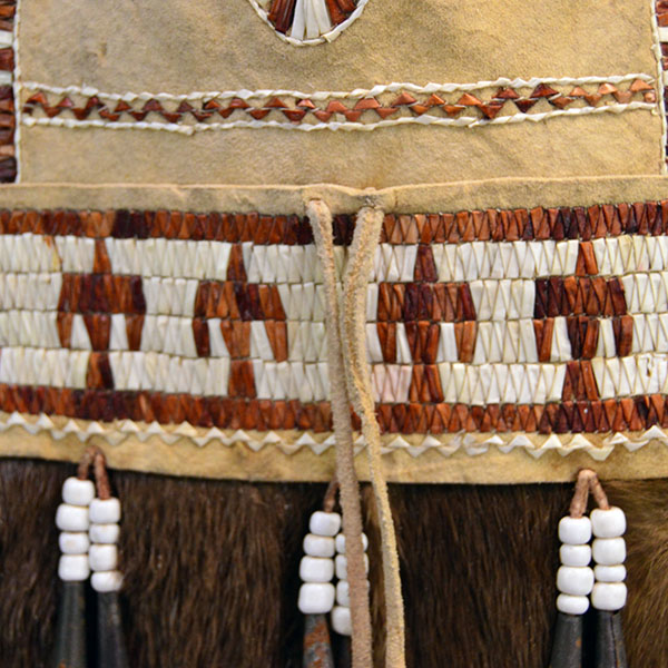 Bag- Quilled Thunderbird Motif with Braintanned leather, otter fur, deer‑hair drops, and antique white pony beads. Measures approx. 14.5" × 6". pictured here is the thunderbird motif on the front of the bag. with the antique white pony beds.