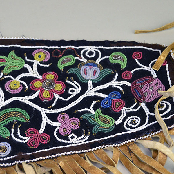 Antique Cree‑style floral beaded jacket shoulder panel with Braintanned fringe, black velvet, bead loss, and ribbon wear; measures 26 inches long. A wider view of the beadwork.