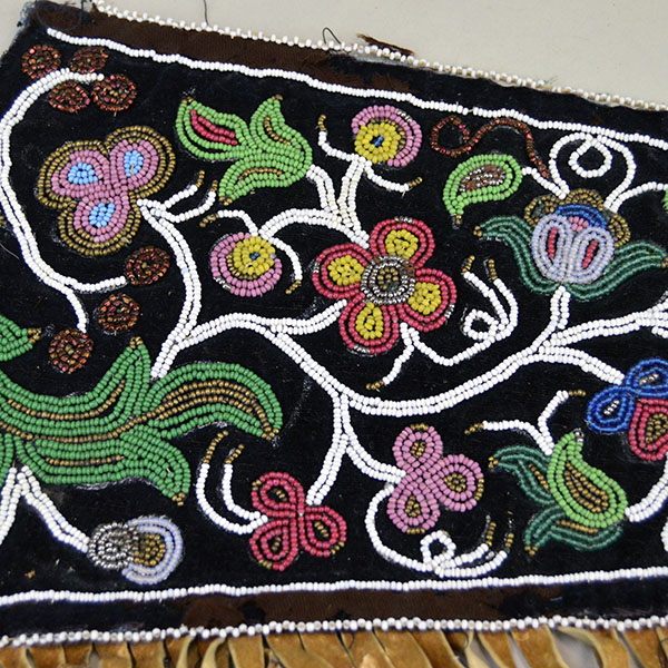 Antique Cree‑style floral beaded jacket shoulder panel with Braintanned fringe, black velvet, bead loss, and ribbon wear; measures 26 inches long. The other side showing the beadwork.