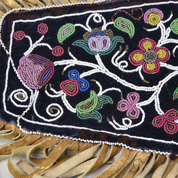 Antique Cree‑style floral beaded jacket shoulder panel with Braintanned fringe, black velvet, bead loss, and ribbon wear; measures 26 inches long. One side of the panels beadwork.