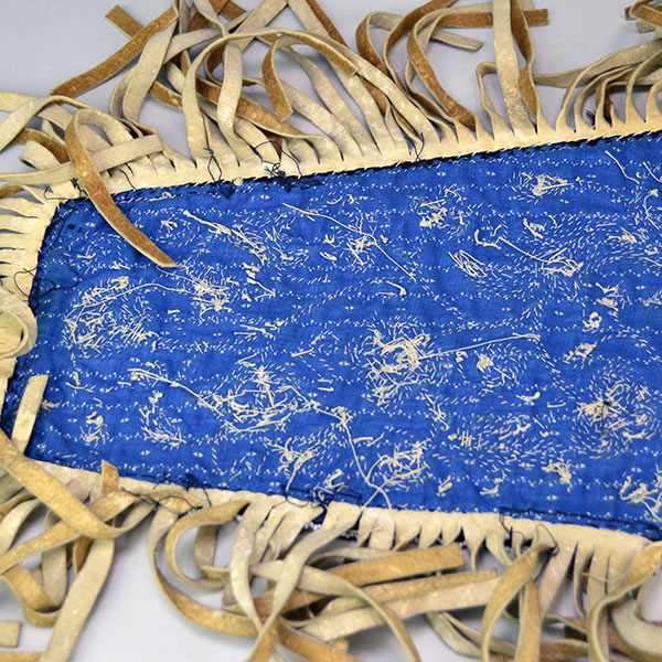 Antique Cree‑style floral beaded jacket shoulder panel with Braintanned fringe, black velvet, bead loss, and ribbon wear; measures 26 inches long. The back showing the other end and the fringe attached.