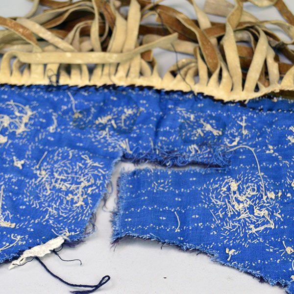 Antique Cree‑style floral beaded jacket shoulder panel with Braintanned fringe, black velvet, bead loss, and ribbon wear; measures 26 inches long. The back showing the rip.