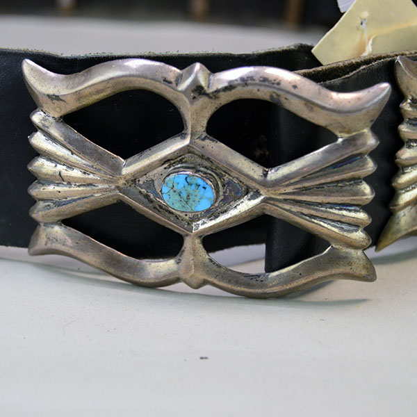 Vintage Belt- Navajo Sandcast Concho with turquoise stones, copper loops on the back of the concho, and adjustable strap. 34" long. One of a Kind. The sandcast concho with the turquoise stone in the middle.