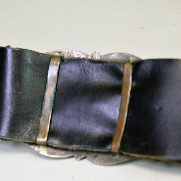Vintage Belt- Navajo Sandcast Concho with turquoise stones, copper loops on the back of the concho, and adjustable strap. 34" long. One of a Kind. The copper loops on the back for the leather to slide through.