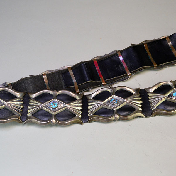 Vintage Belt- Navajo Sandcast Concho with turquoise stones, copper loops on the back of the concho, and adjustable strap. 34" long. One of a Kind. Picture of the front and back of the belt.