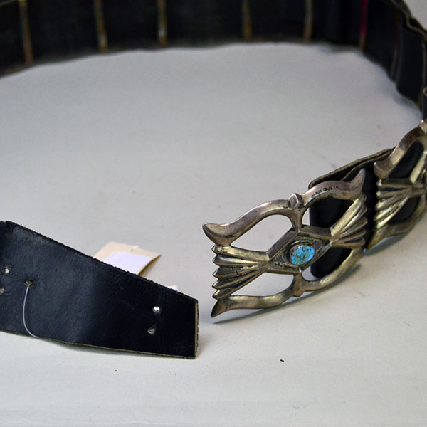 Vintage Belt- Navajo Sandcast Concho with turquoise stones, copper loops on the back of the concho, and adjustable strap. 34" long. One of a Kind. The holes in the strap leather to adjust the size.