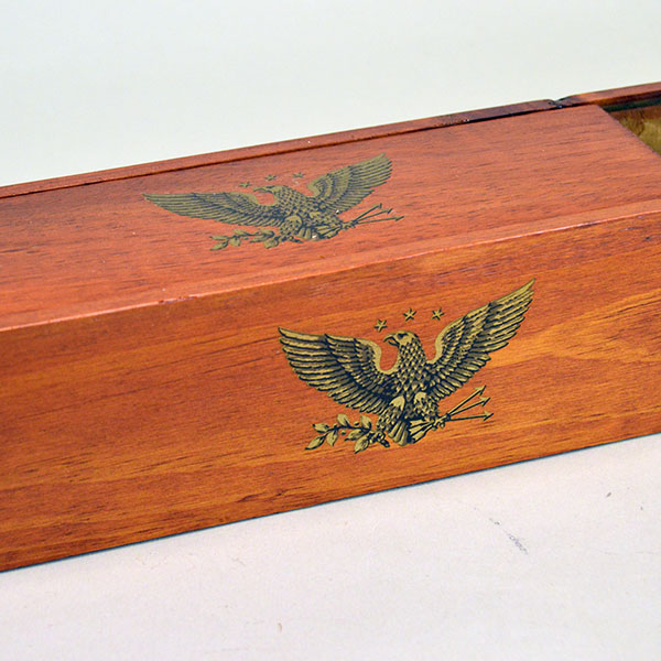Box- Cedar Feather Case, 17"x 3 "x 2.75" . Recycled cedar feather case with eagle decals and a smooth sliding lid for secure feather storage. The top and side showing the eagle decals.