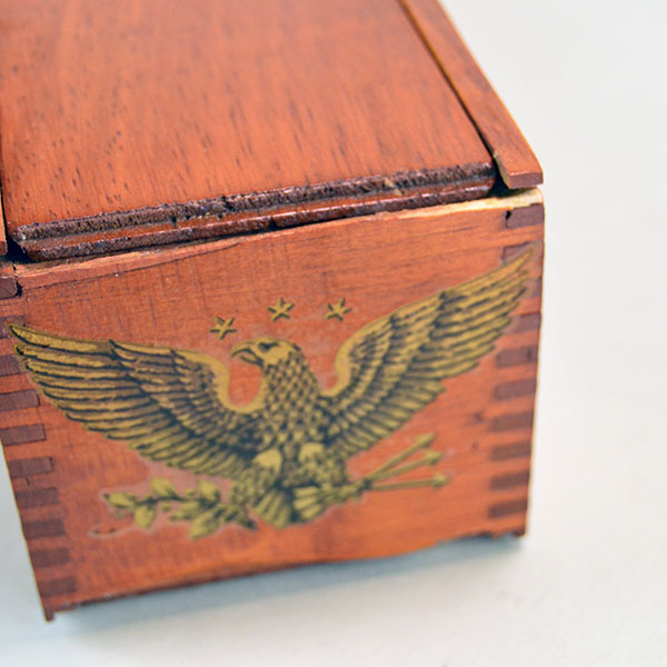 Box- Cedar Feather Case, 17"x 3 "x 2.75" . Recycled cedar feather case with eagle decals and a smooth sliding lid for secure feather storage. The end view.