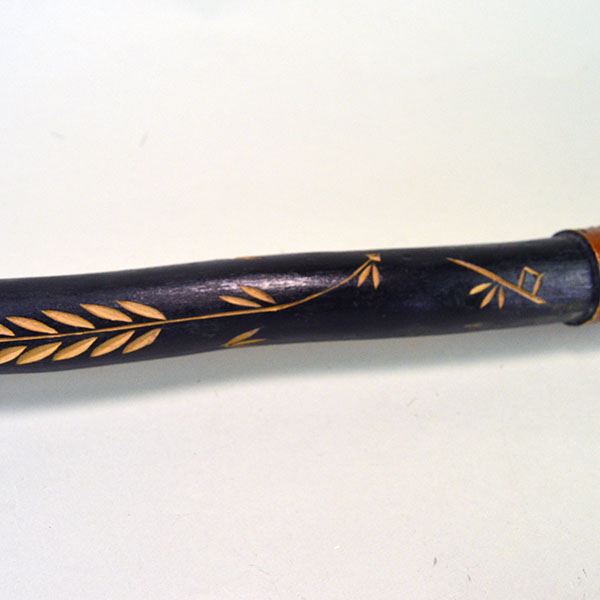 Vintage birch Cane- Indian Head & Leaves, approx. 36" long and 1.5" wide, featuring a hand‑chipped portrait, chipped leaf designs, hand‑painted details. the back of the canes chipped design.