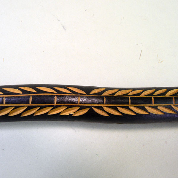 Vintage birch Cane- Indian Head & Leaves, approx. 36" long and 1.5" wide, featuring a hand‑chipped portrait, chipped leaf designs, hand‑painted details. Up close picture of the chipped leave design down the front.