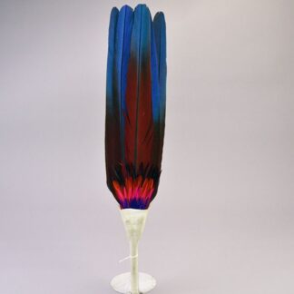 Vibrant Fan Flat- Macaw Feathers, pink‑blue‑orange accent feathers, white leather handle, twisted tassels; approx. 17″ long with 12″ feathers.
