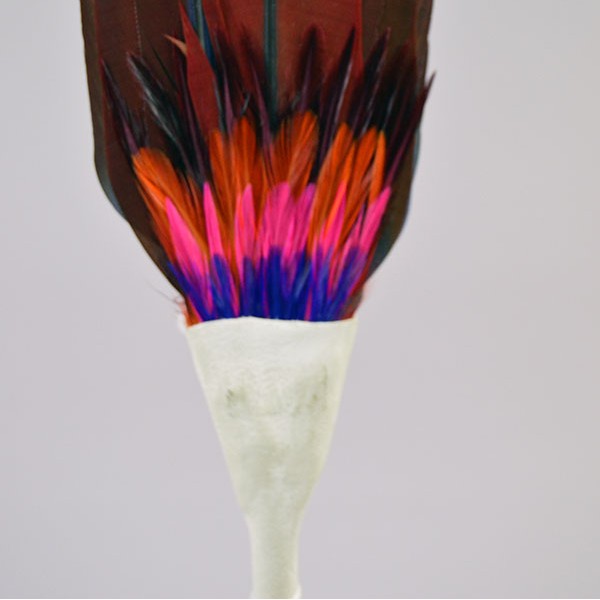 Vibrant Fan Flat- Macaw Feathers, pink‑blue‑orange accent feathers, white leather handle, twisted tassels; approx. 17″ long with 12″ feathers. the pink, blue and orange accent feathers.
