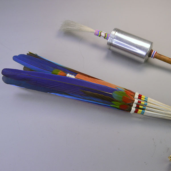 Handcrafted Gourd Dance Rattle Fan Set with bold beadwork, vibrant Macaw feathers, Ermine accents, and premium details for standout regalia.. Pictured here is the top of the rattle showing the white horse hair and the colors of the fan.