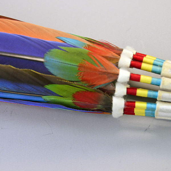 Handcrafted Gourd Dance Rattle Fan Set with bold beadwork, vibrant Macaw feathers, Ermine accents, and premium details for standout regalia.. There is a picture with the macaw feather against the thread work at the base.