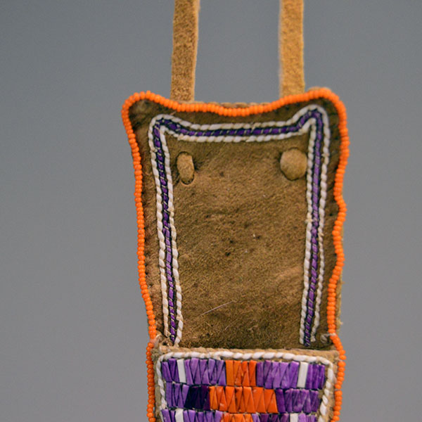 Knife Sheath- Hand Quilled smoked Braintanned deer‑skin with vibrant quillwork, seed‑bead edging, rawhide blade protection, and an adjustable neck strap. The top of the sheath showing the edge beading.