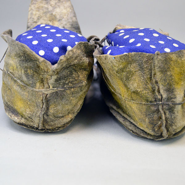 Antique Moccasins- Arapaho Style Child's with a bold cross design, intact 11/0 beadwork, Braintanned hide, rawhide sole, and early 1900s craftsmanship. Pictured here is the backs.