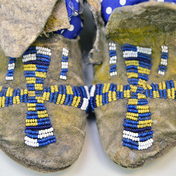 Antique Moccasins- Arapaho Style Child's with a bold cross design, intact 11/0 beadwork, Braintanned hide, rawhide sole, and early 1900s craftsmanship. Pictured here is the cross beaded vamps.