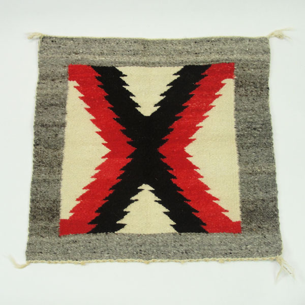 Handmade Navajo Rug Pair with Eye‑Dazzler and geometric designs in rich wool colors. The measurements for both are approx. 18" x 19" and 19.5" x 20". The eye dazzler pattern.