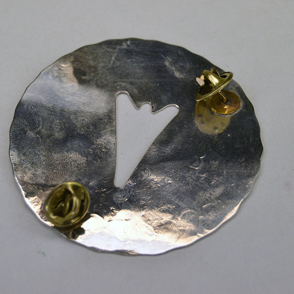 Add this Pin- Concho Arrowhead Silhouette to your collection. A 2.5‑inch German silver concho with hand‑stamped detailing and dual pins for secure. The back showing the pins.