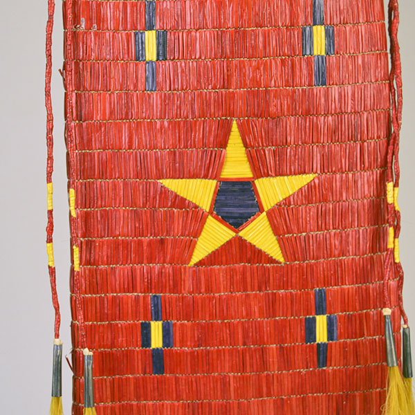 Pipe Bag- Double-sided Quillwork, Braintanned deerskin, braided fringe, cone‑drop tassels, and brass bells. Measures 45" with light age wear. the front quill work design.